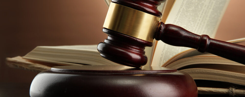 immigration law attorney desk with a gavel and law book on it